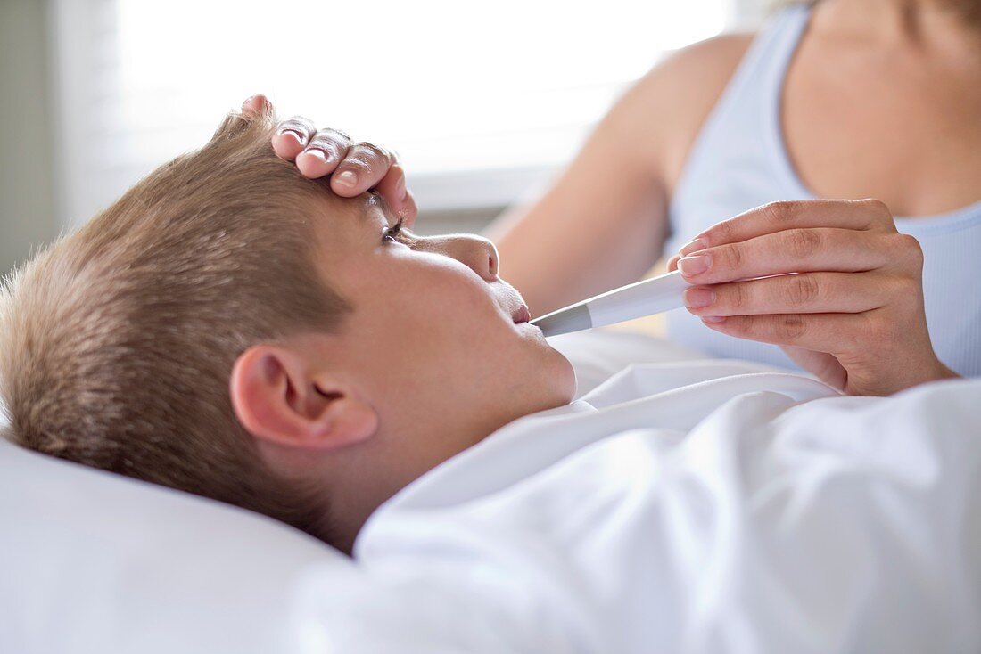 Boy having his temperature taken