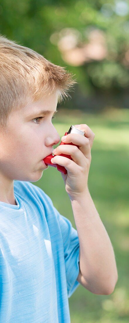 Young boy using an inhaler