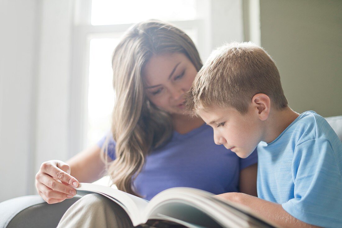 Mother and son reading a book together