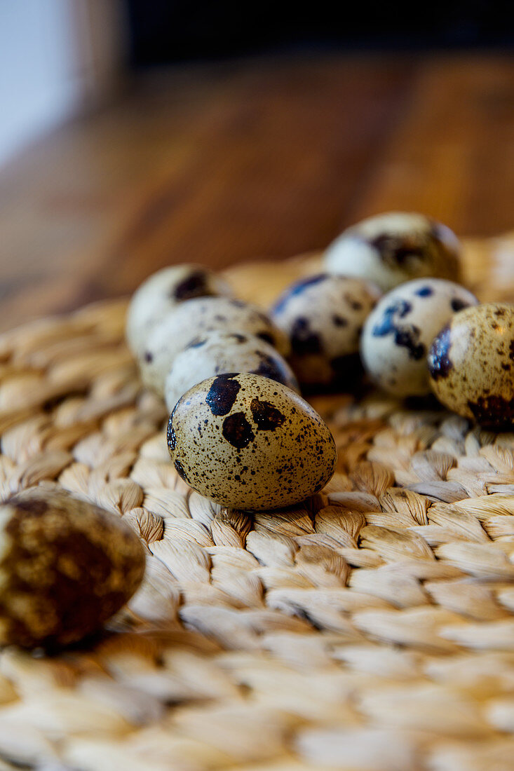 Quail eggs on a woven basket coaster