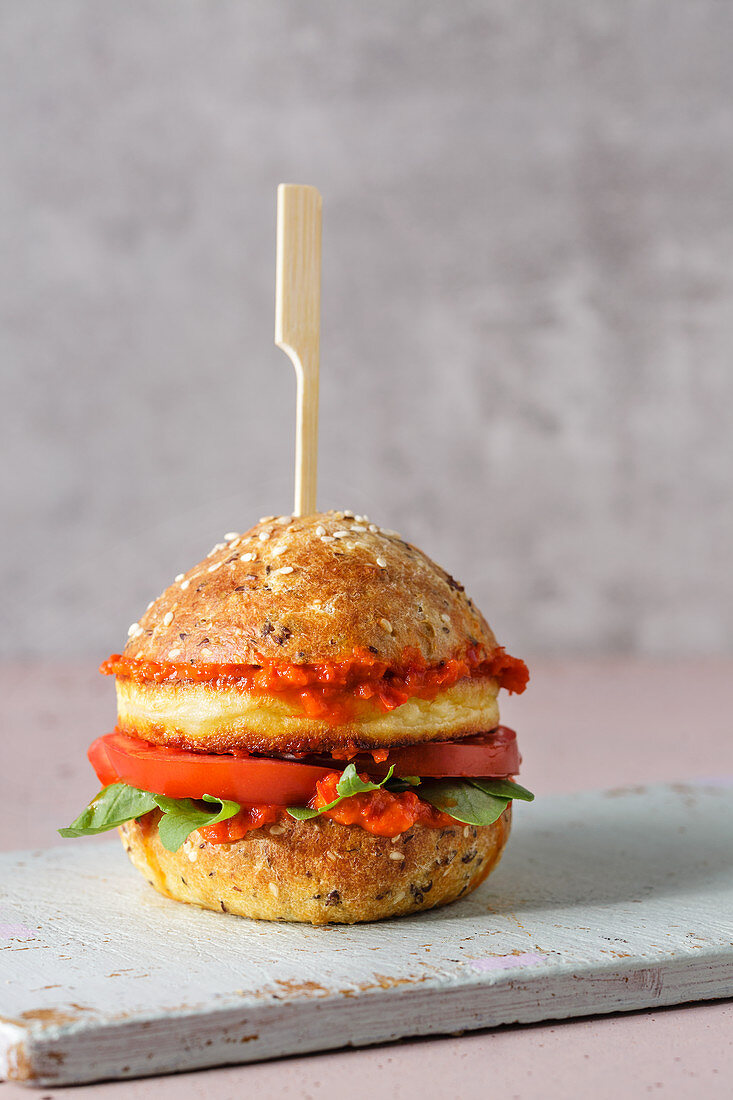 Low-carb sesame seed and grilled cheese burger with ajvar