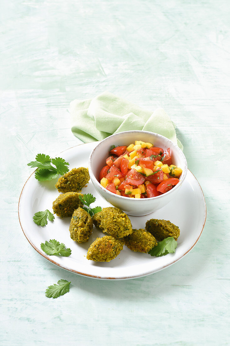 Yellow lentil falafels with a mango and tomato dip