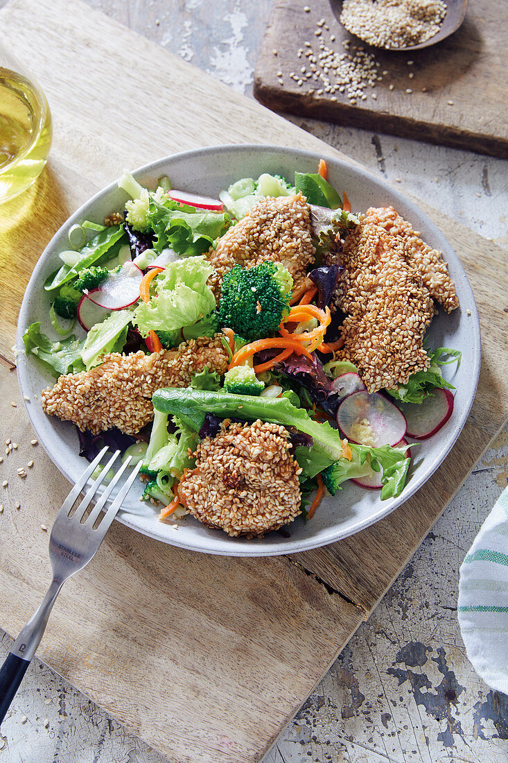 A vegetable salad with sesame seed chicken