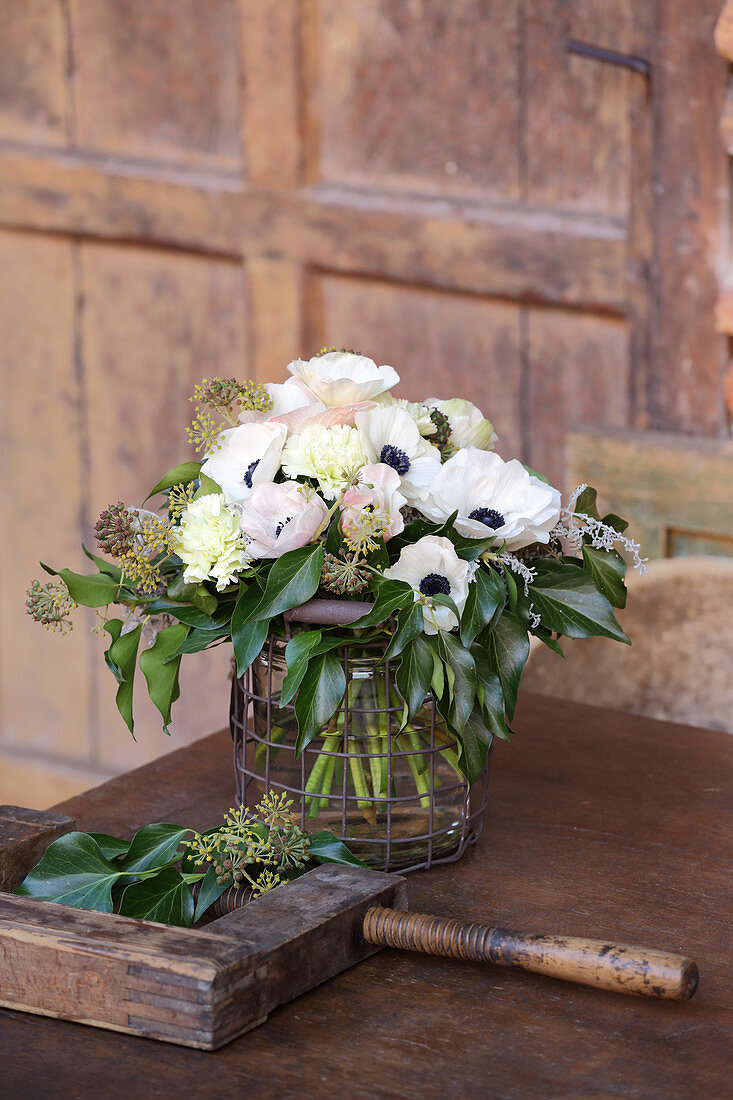 Bouquet of anemones, carnations, ivy and ivy berries