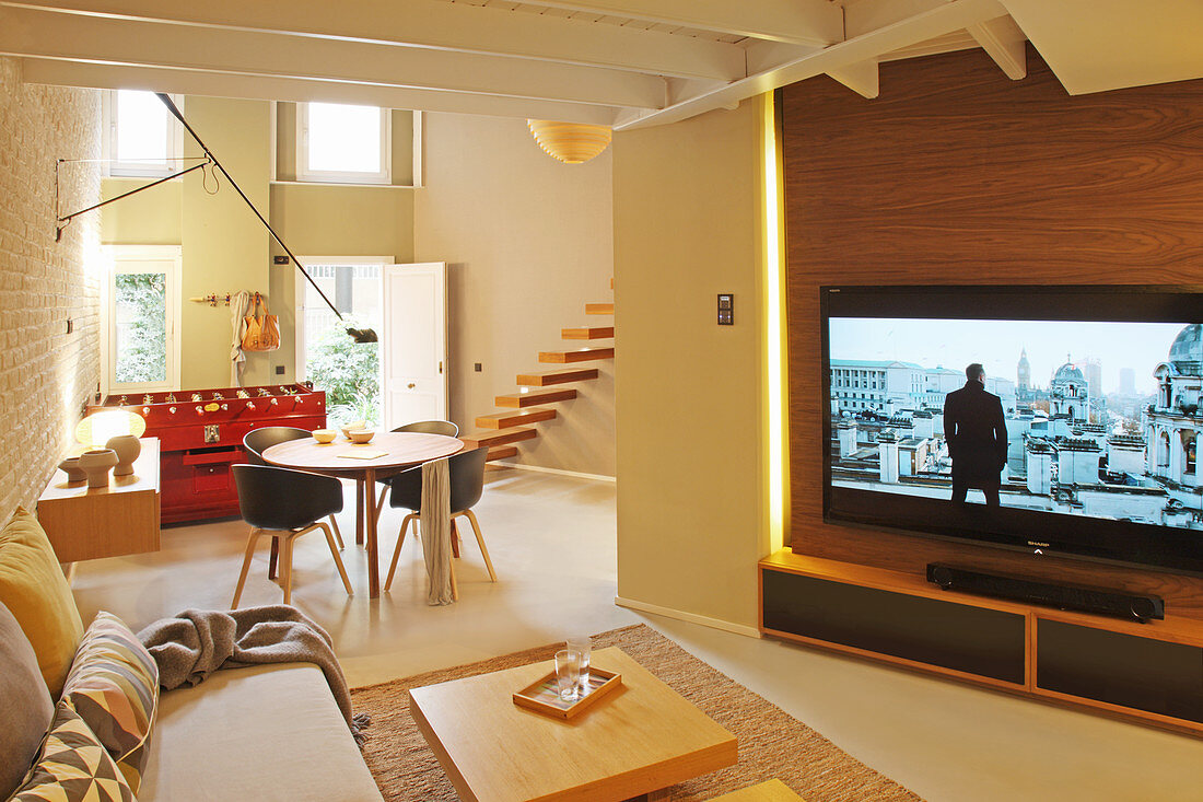 Large TV in open-plan interior with front door in background