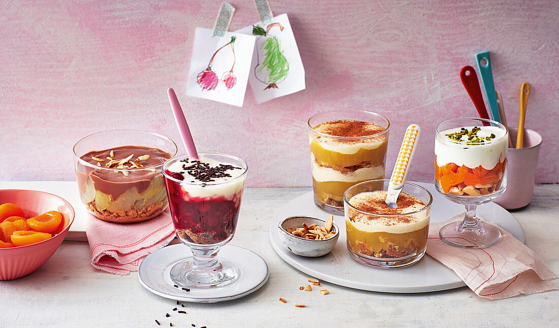 Pear and chocolate trifle, cherry and rice pudding trifle, apple and semolina trifle, and apricot trifle