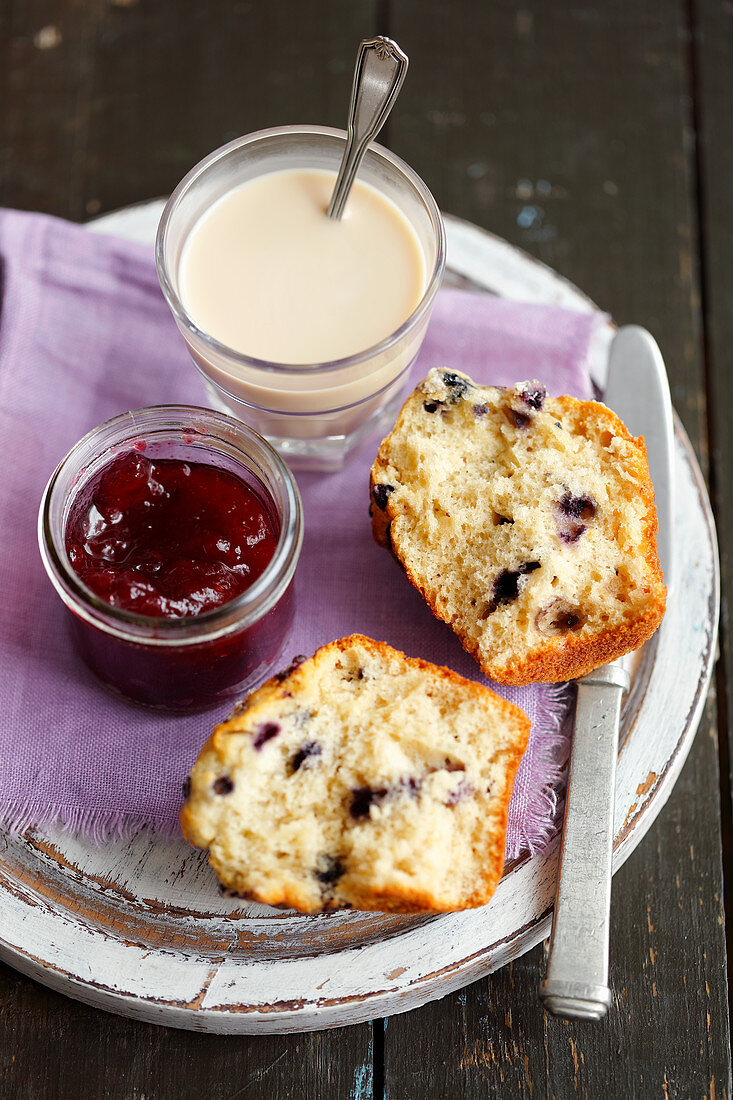 Blueberry muffin with jam and white coffee