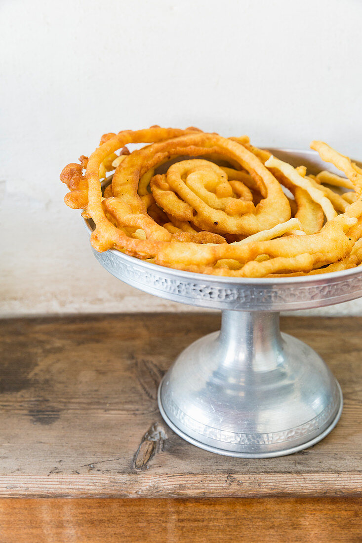 Deep-fried pastries on a cake stand