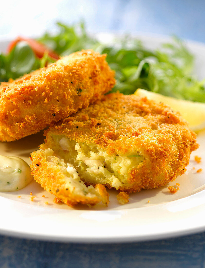 Breaded haddock cakes with salad