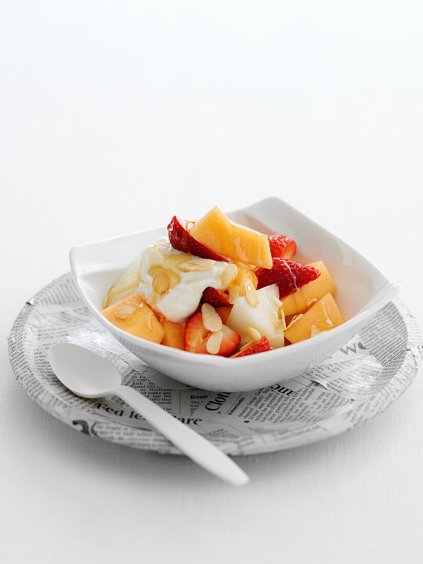 Strawberry and melon salad with ginger, honey, yoghurt and almonds