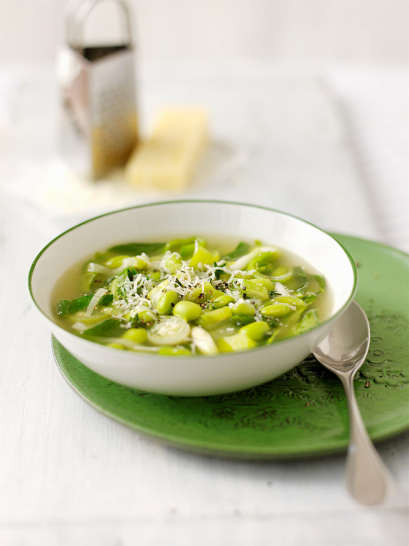 Spring vegetable soup with grated cheese