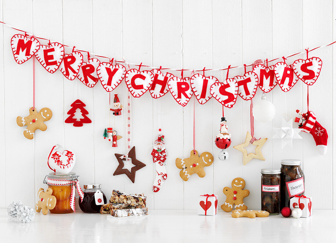 A 'Merry Christmas' lettering decoration, gingerbread men, and canned gifts