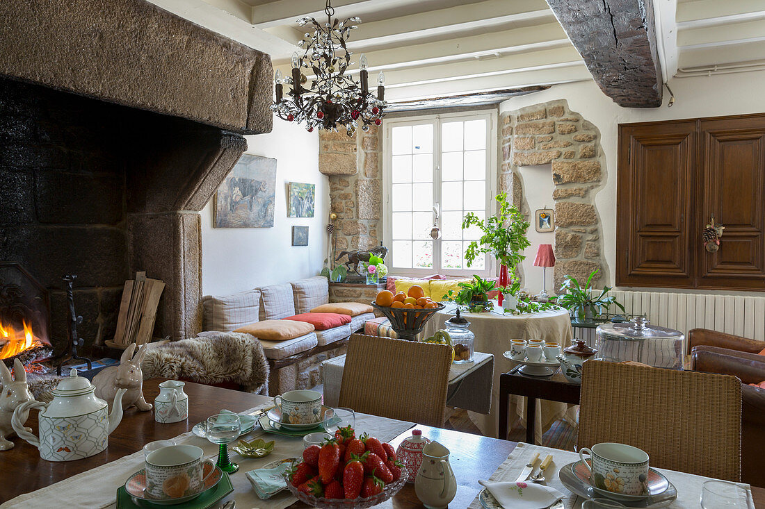Open fireplace and stone walls in traditional dining room