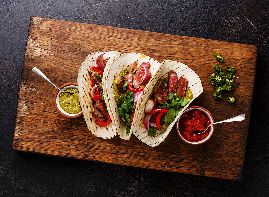 Grilled Beef steak Fajitas taco tortillas with salsa and bell pepper