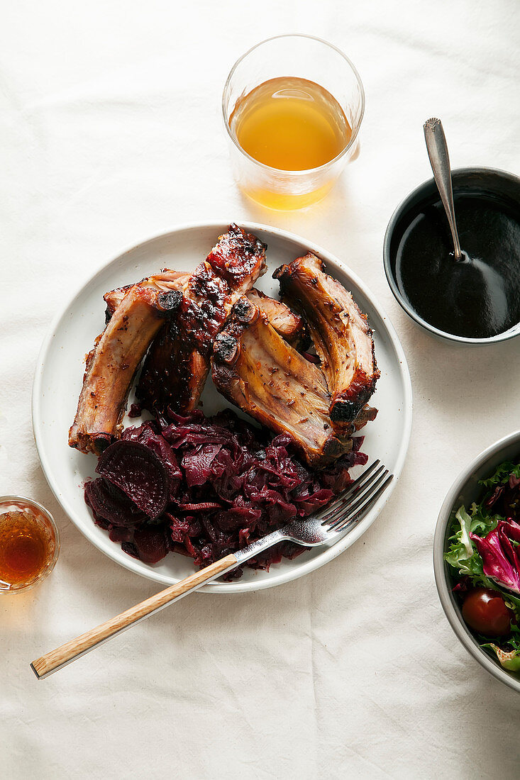 Grilled pork ribs cooked with balsamic vinegar and honey sauce, garnished with red wine braised red cabbage with beets