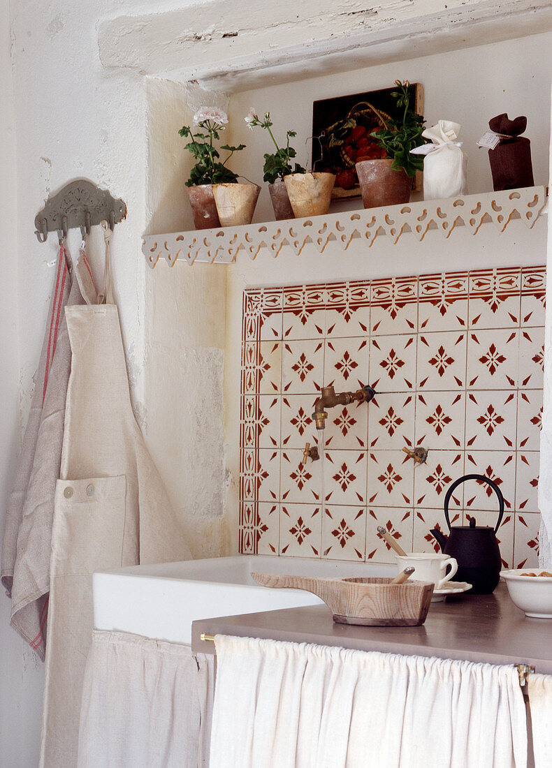 Mediterranean wall tiles above sink in country-house kitchen