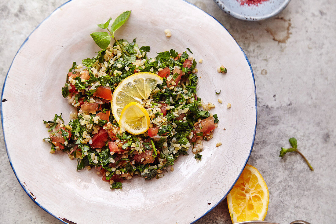 Traditional jewish and middle eastern food tabouli witn fresh mint, parsley and tomatoes