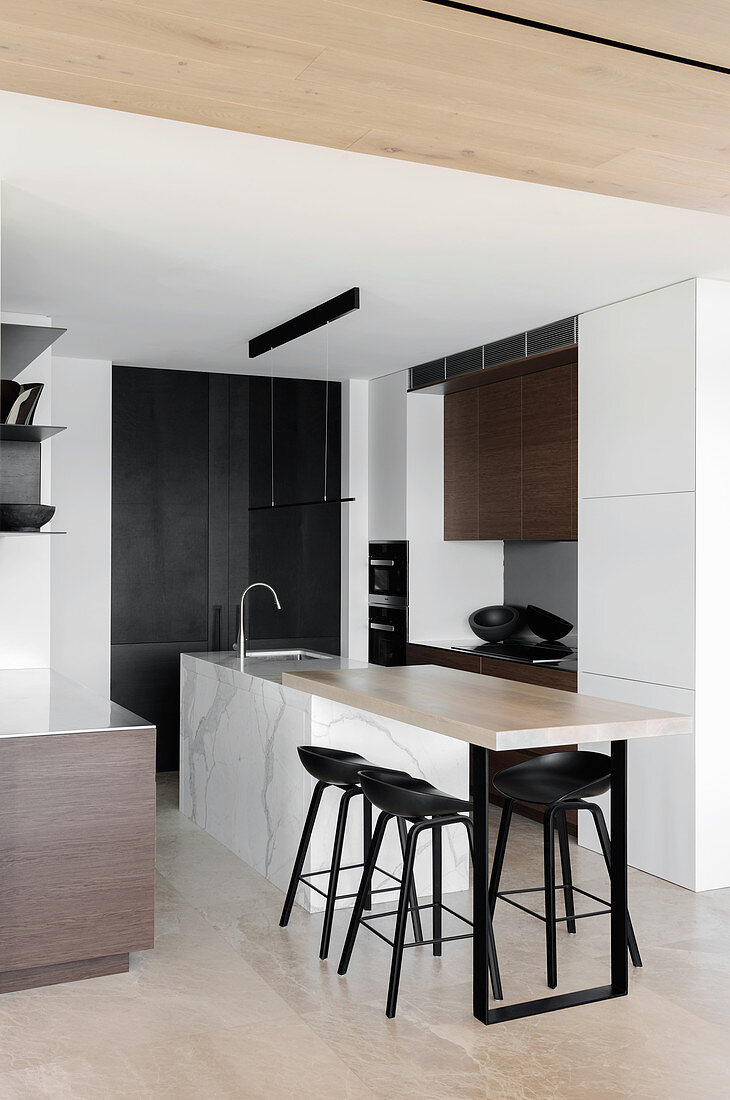 Kitchen island with an extended counter and bar stool in an open kitchen