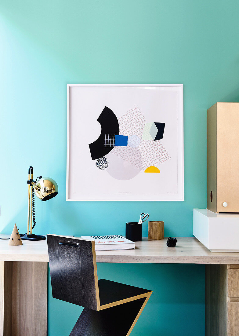 Zig-Zag-Stuhl am Schreibtisch im Arbeitszimmer mit türkisfarbener Wand