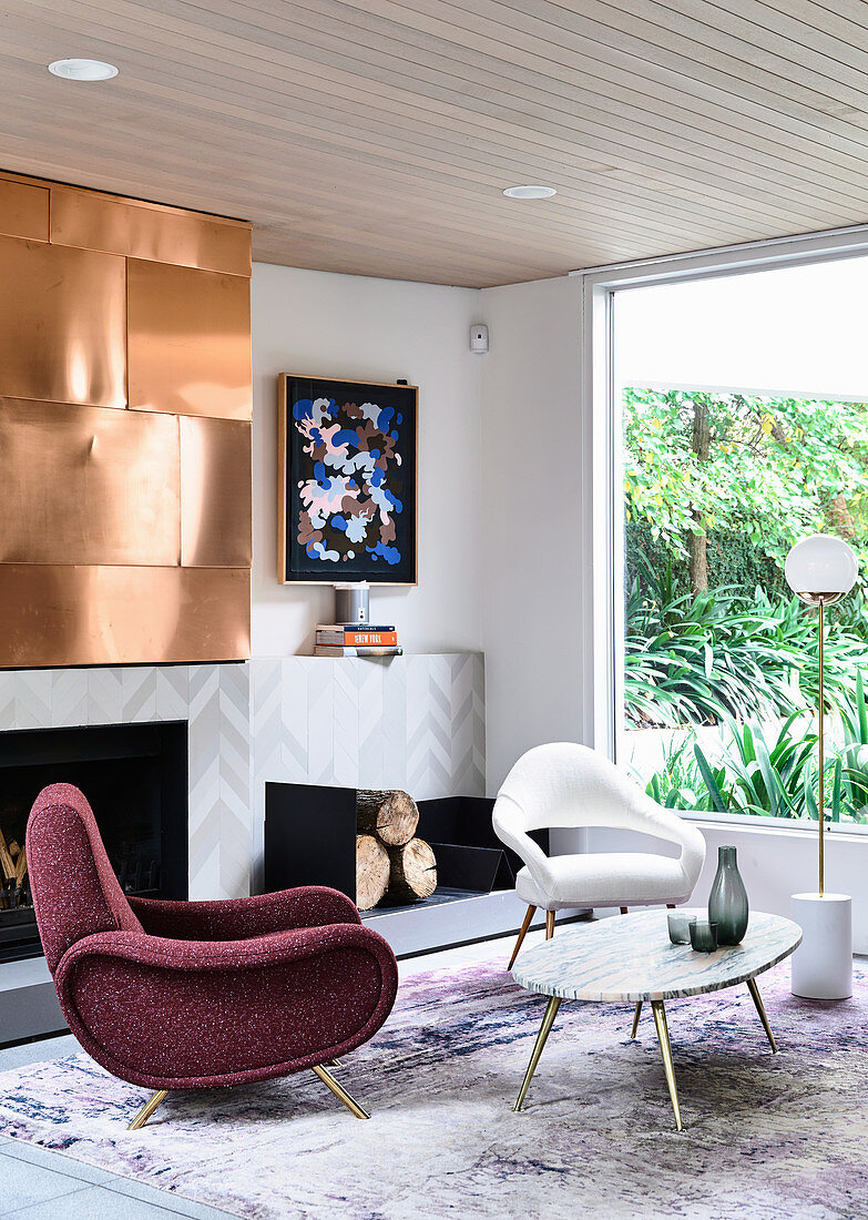 Lounge area with designer seating and fireplace, copper plate above