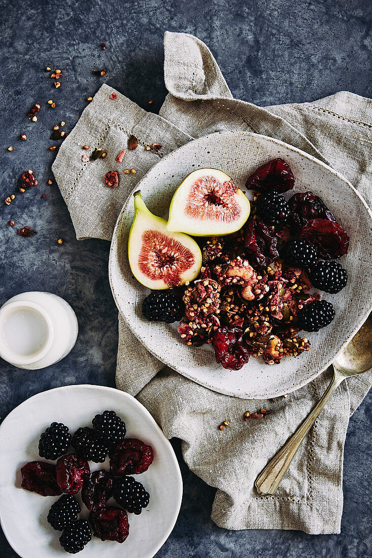 Glutin free berry buckweat and cashew nut breakfast clusters. toped with dried plums and fresh fruit