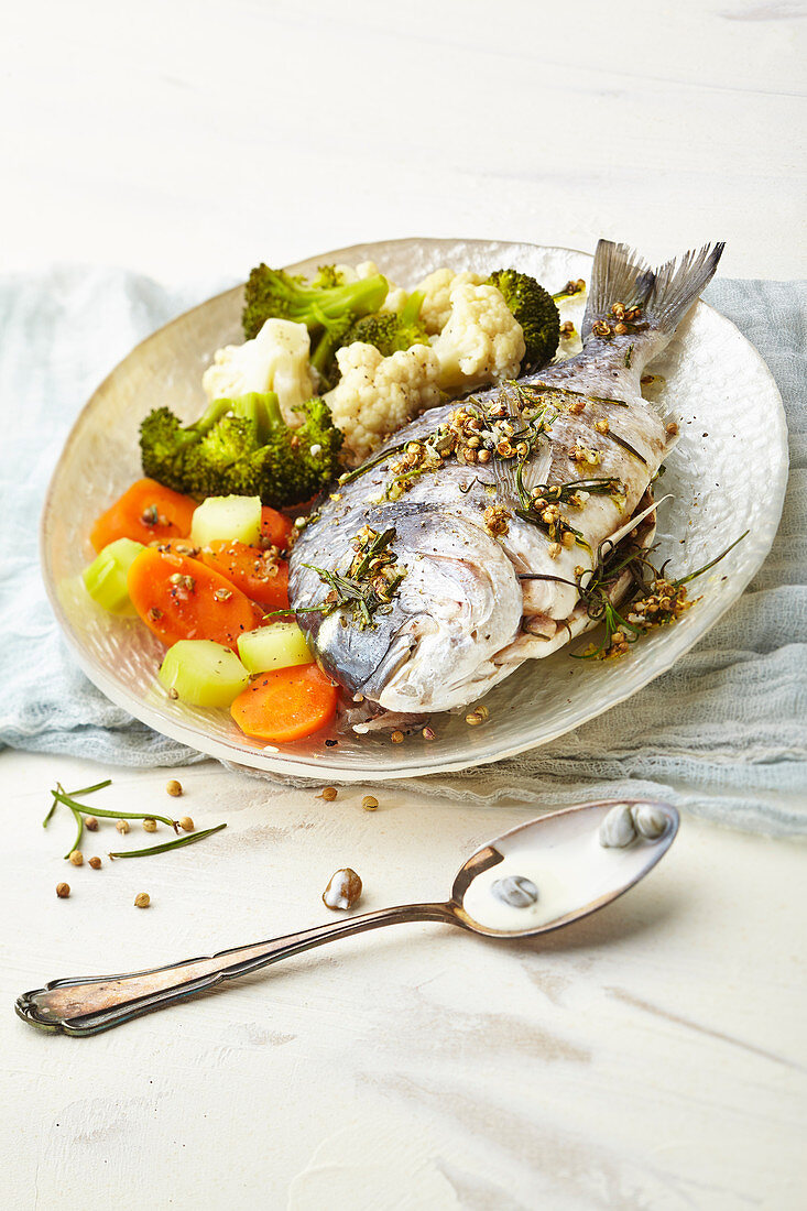 Herb bream with caper sauce and vegetables