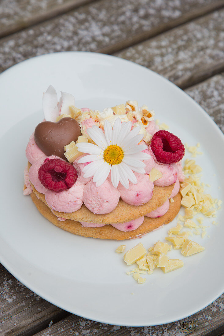 A slice of lavishly decorated flower-shaped cake with raspberry mascarpone cream