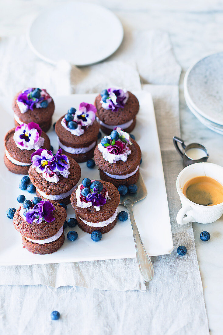Chocolate cakes with blueberry cream and pansies