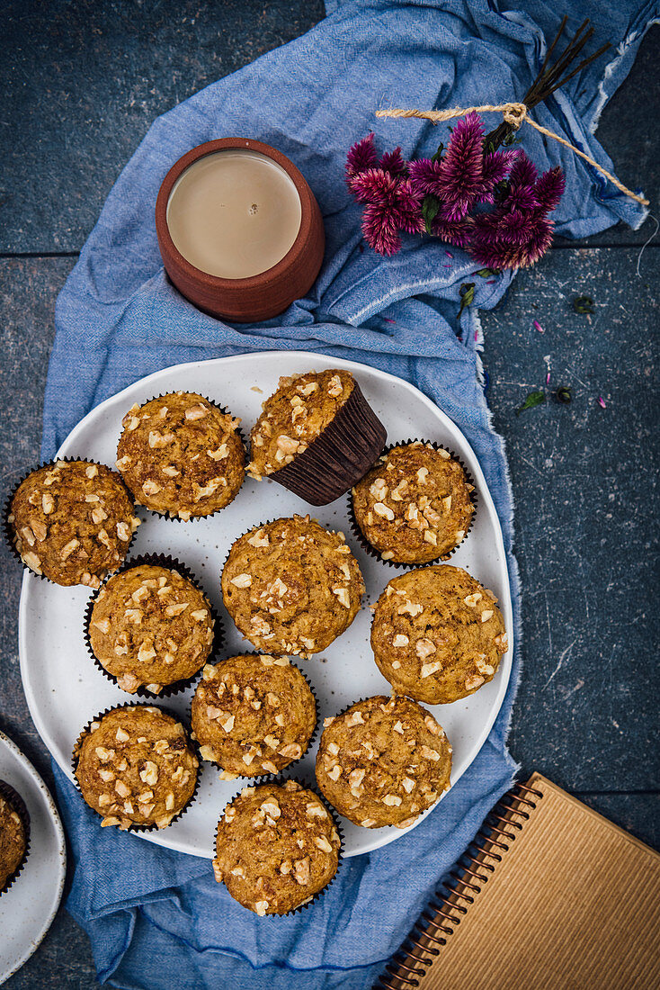 Banana nut muffins served on a large white ceramic plate photographed from top view