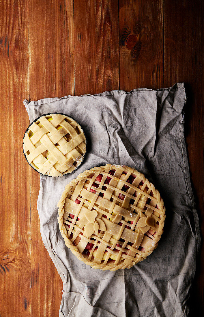 Various ways of pie decoration with lattice and leaves, Apple, strawberry and raspberry pies, uncooked