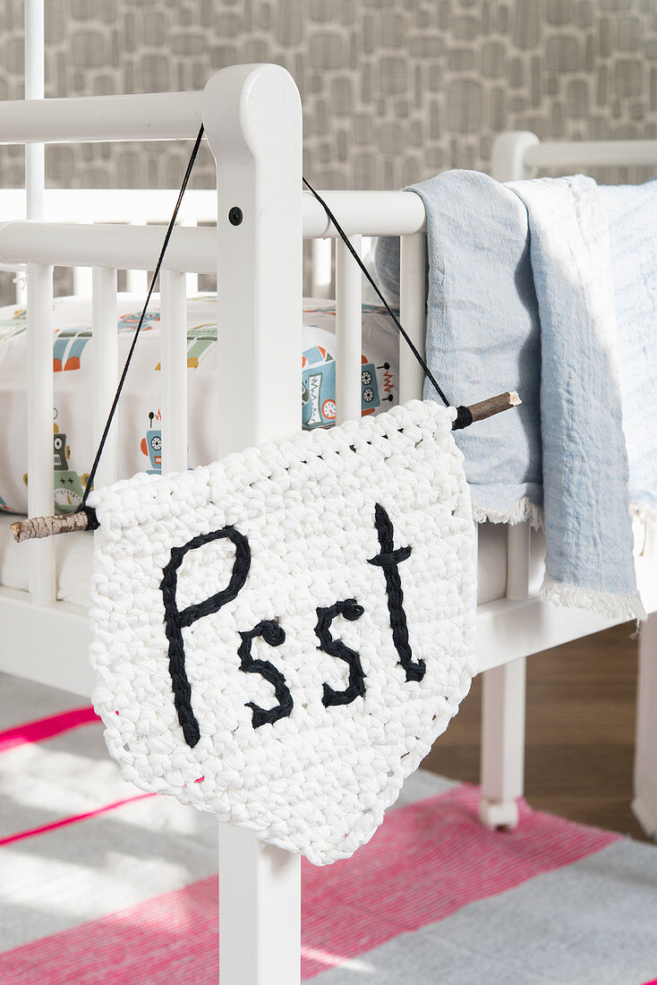 A crocheted door sign