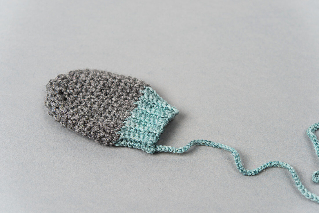 A crocheted baby glove