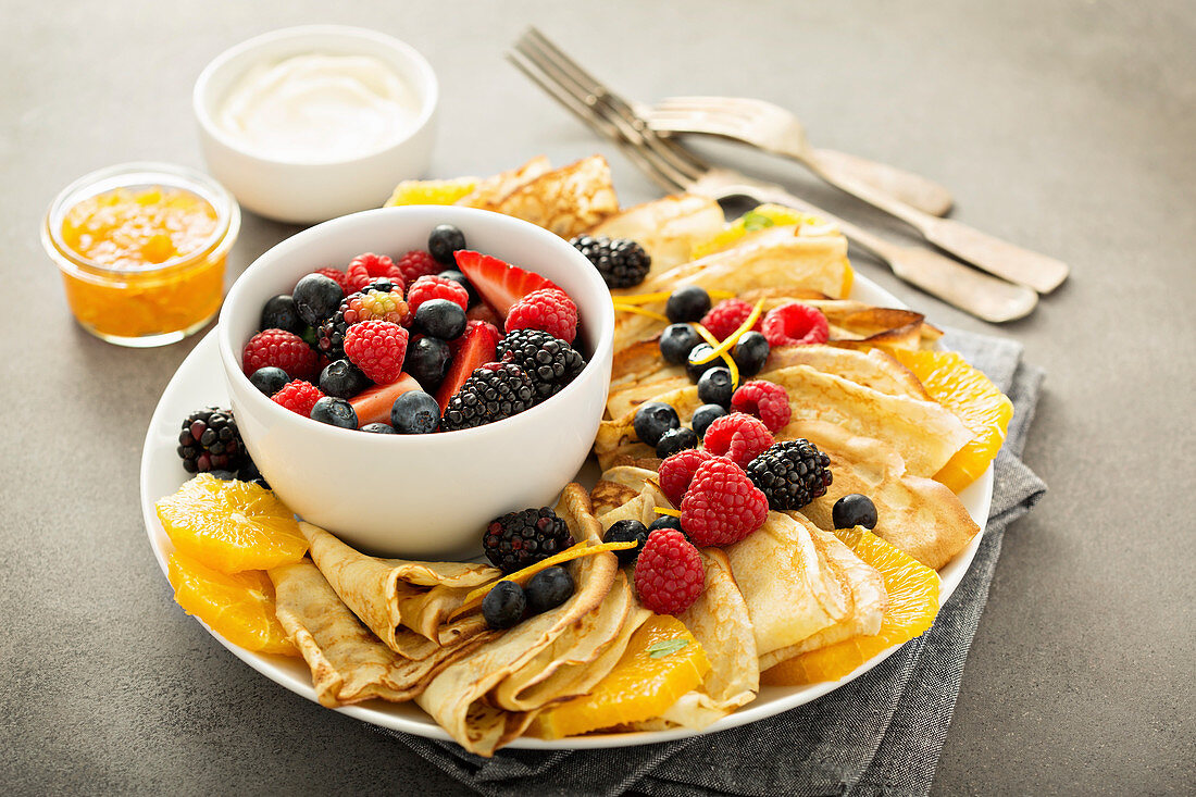 Thin crepes with fresh fruit and berries served with orange marmalade and cream cheese spread