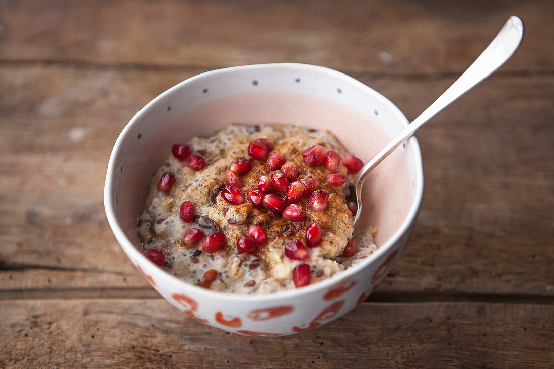 Porridge topped with pomegranate and cinnamon