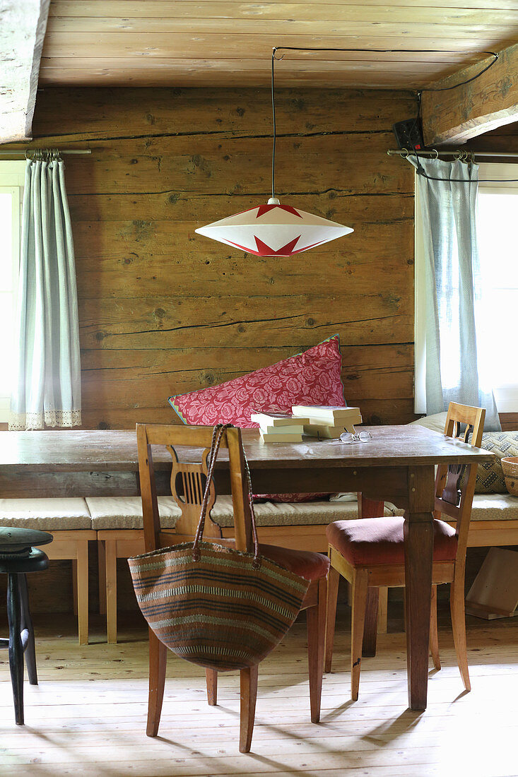 Hand-made paper lampshade over rustic dining table
