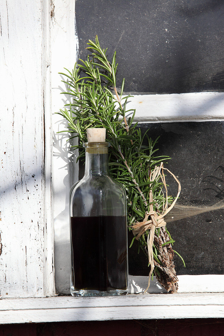Homemade hair oil made from birch leaves, stinging nettles, rosemary and olive oil