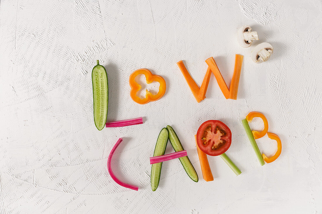 The phrase 'low carb' written in vegetable sticks