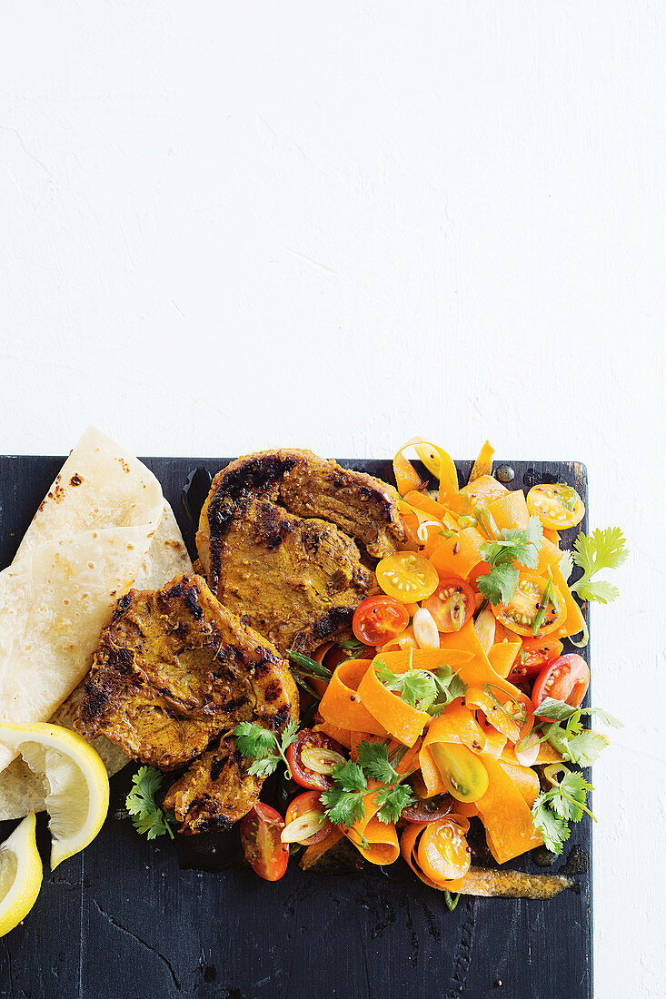 Scorched tikka lamb chops with tomato and carrot salad