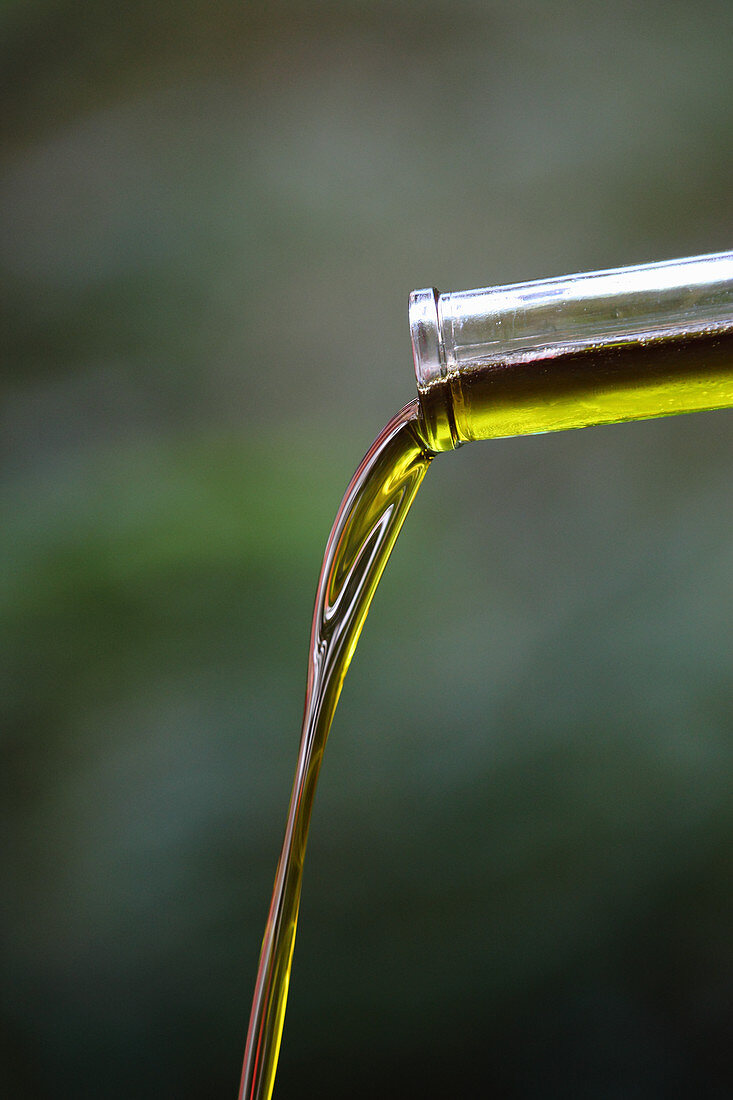 A homemade oil extract being poured from a bottle