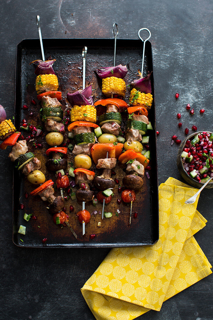 Pork and vegetable kebabs with pomegranate salsa