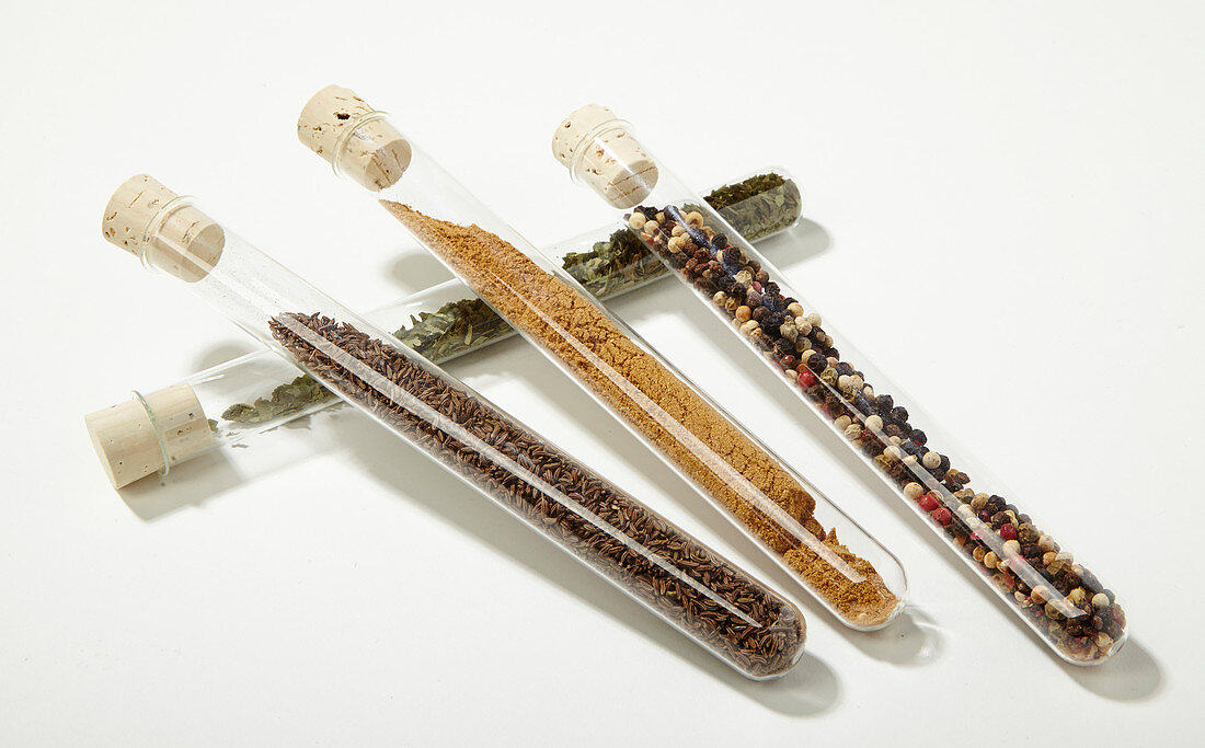 Various spices in test tubes with cork stoppers