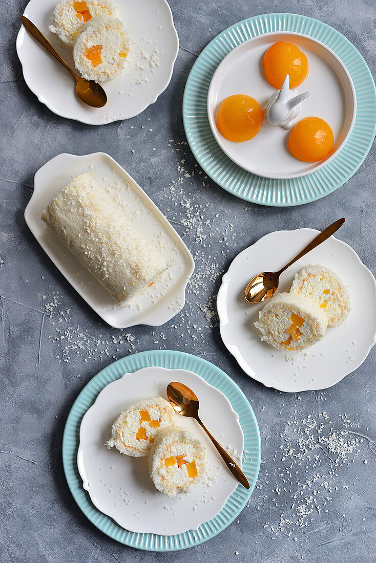 Meringue coconut roll with whipped cream and peaches