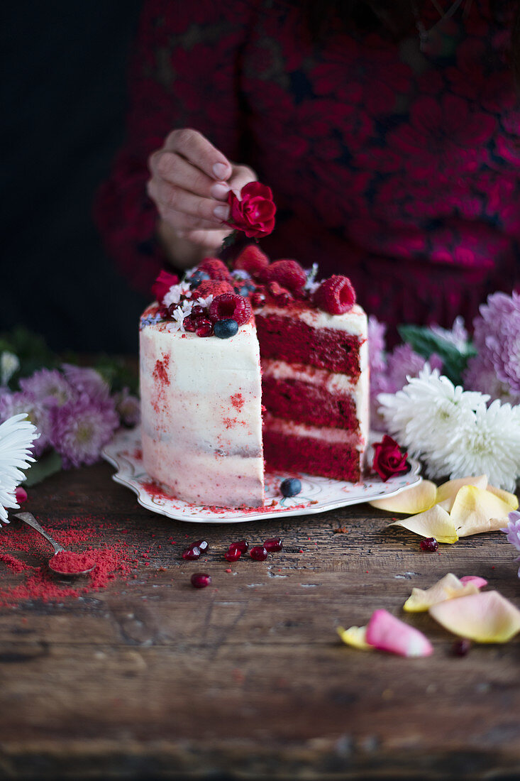 Red velvet layer cake topped with raspberries