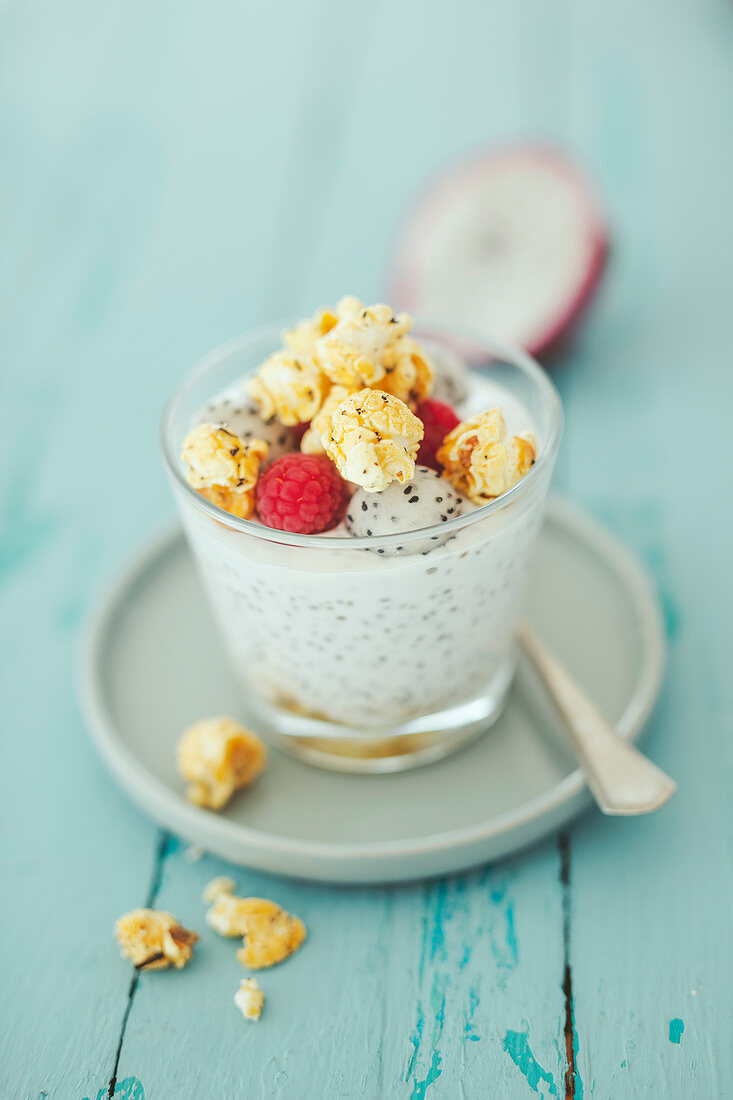 Chia pudding with coconut yoghurt with lime popcorn and dragon fruit in a glass