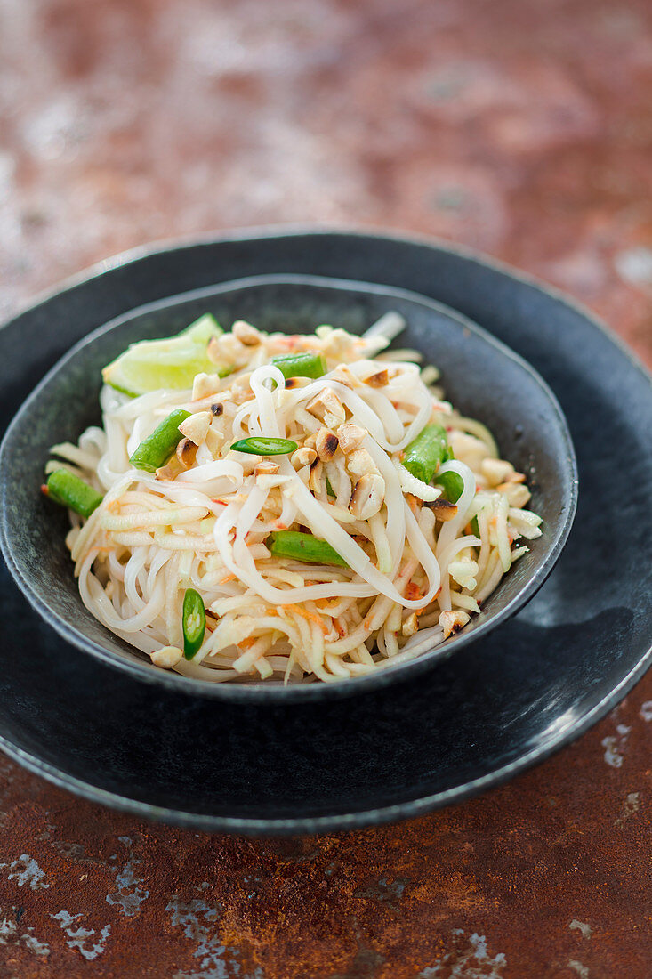 Salad with green papaya, yardlong beans and wide rice noodles (vegan)