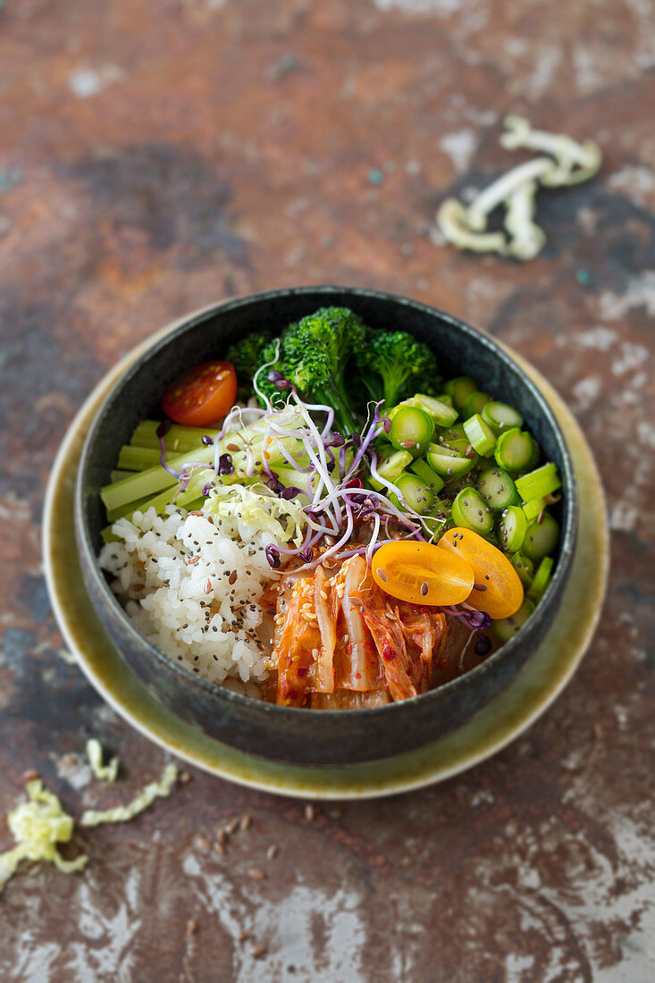 Poke bowl with celery, broccolini, green asparagus and kimchi