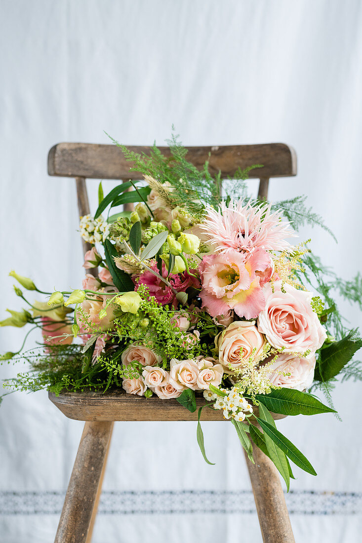 Pink bridal bouquet on vintage chair