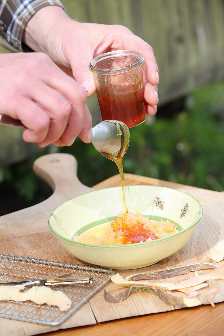 A man making cough syrup by pouring honey over grated radishes