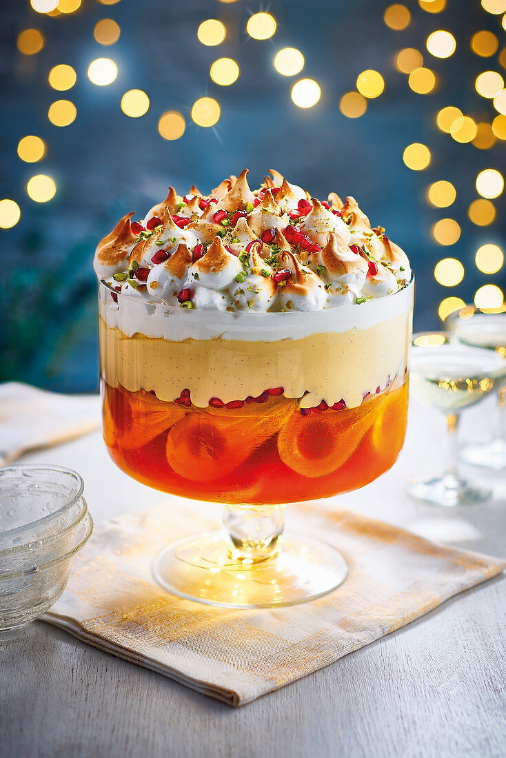 Boozy poached pear and pomegranate trifle with a saffron jelly set on a beed of sweet amaretti biscuits with a creamy vanilla custart and topped with a torched italian meringue pistachios and pomegranate seeds