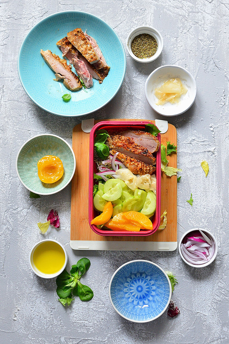 A healthy lunchbox with chicken, cucumber, ginger and lettuce